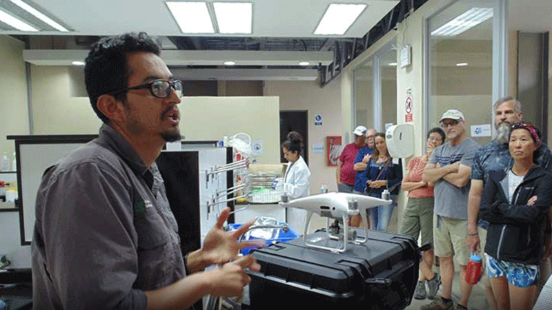 A GSC researcher speaks to a crowd of visitors inside the GSC Terrestrial Ecology Lab.