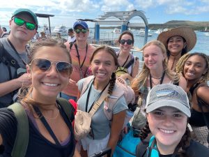 A group selfie of Patton Mebel and eight other study abroad students at the oceanfront.