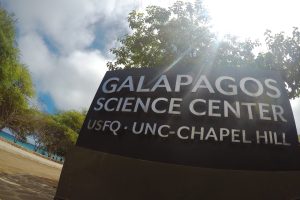 A sign outside the Galapagos Science Center with the center's name, "USFQ," and "UNC-Chapel Hill" written on it.